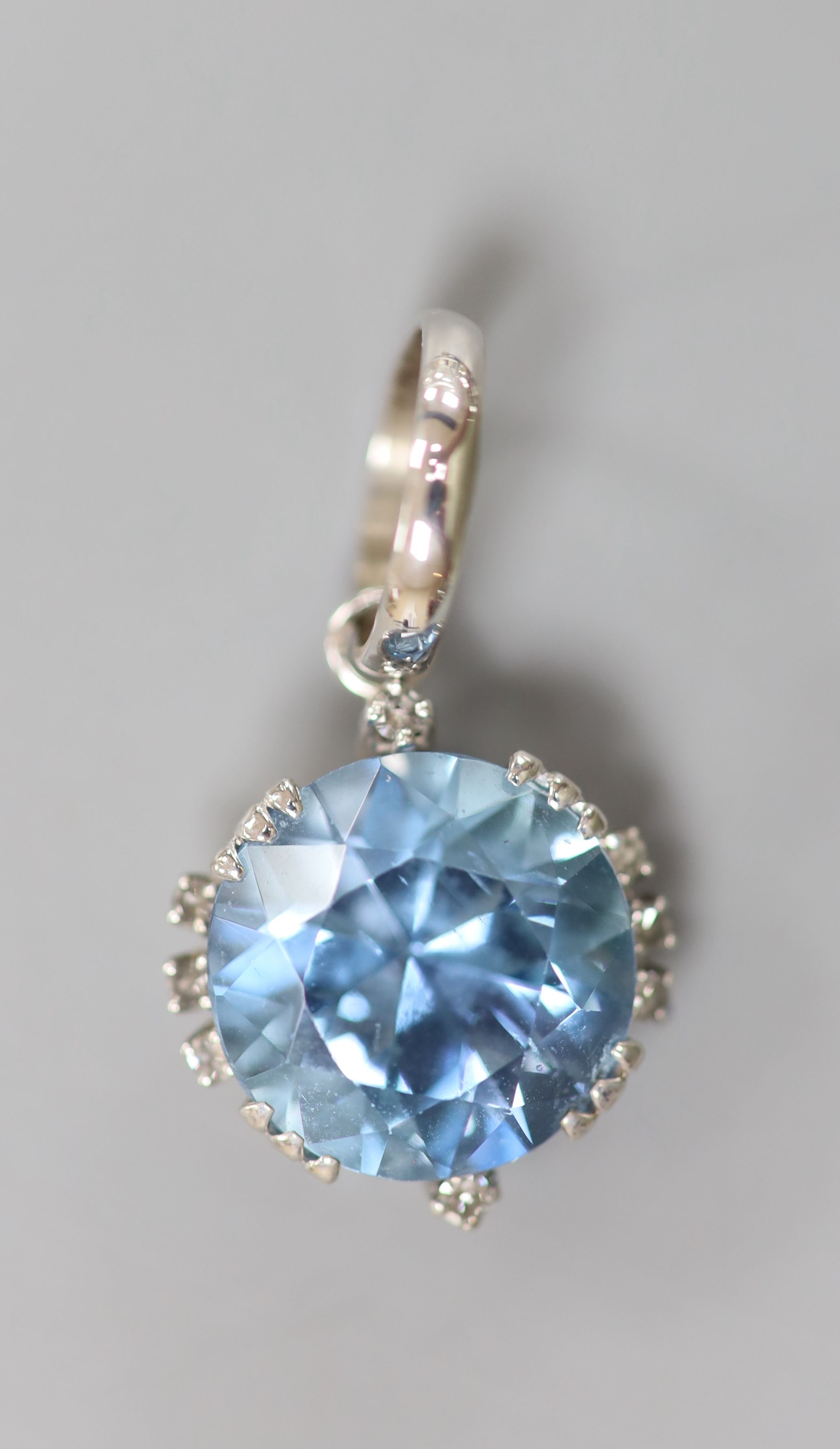 A modern pair of white metal, aquamarine and diamond set ear studs and a matching pendant